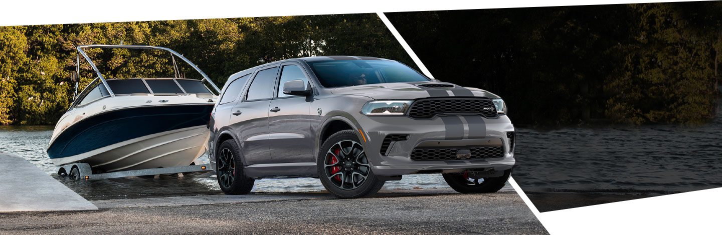 The 2021 Dodge Durango SRT towing a boat out of the water.
