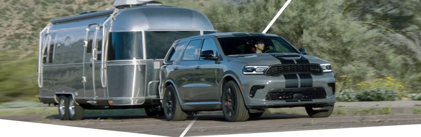 The 2021 Dodge Durango SRT towing a streamlined RV trailer.