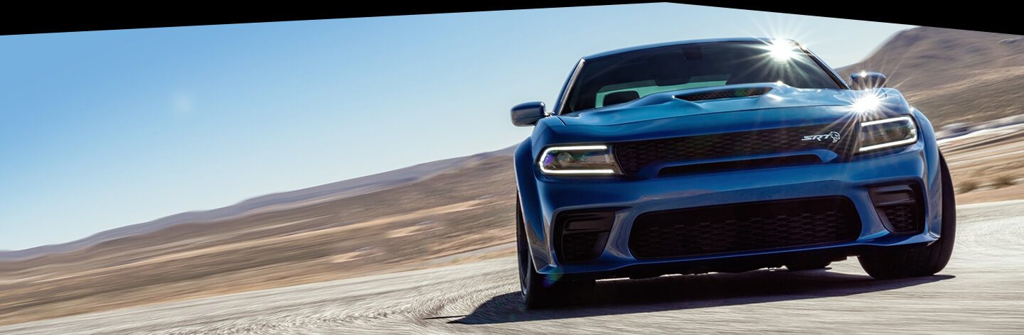 The 2020 Dodge Charger SRT Hellcat Widebody being driven on a race track.