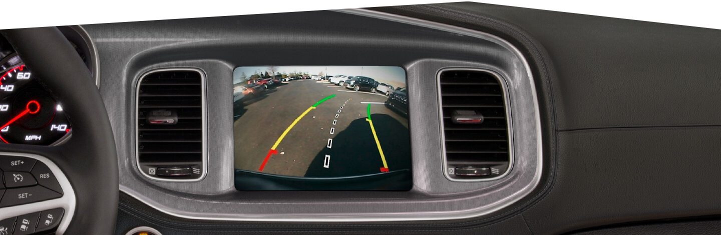 The touchscreen on the 2020 Dodge Charger showing the area behind the vehicle with guidelines overlaid on the screen.